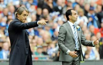 epa03696536 Wigan Athletic's Manager Roberto Martinez (R)  and Manchester City Manager Roberto Mancini (L) give instructions to their players during the English FA Cup final soccer match between Manchester City and Wigan Athletic at Wembley in London, Britain, 11 May 2013.  EPA/ANDY RAIN DataCo terms and conditions apply. https://www.epa.eu/downloads/DataCo-TCs.pdf