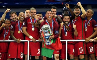 PARIS, FRANCE - JULY 10:  Cristiano Ronaldo of Portugal (c) lifts the European Championship trophy after his side win 1-0 against France during the UEFA EURO 2016 Final match between Portugal and France at Stade de France on July 10, 2016 in Paris, France.  (Photo by Matthias Hangst/Getty Images)