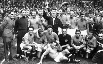 Italy's national soccer team poses with the World Cup trophy after beating Hungary 4-2 in the World Cup final, 19 June 1938 in Colombes, in the suburbs of Paris.(Standing from L : Amadeo Biavati (4th L), coach Vittorio Pozzo holding the trophy, Silvio Piola, Giovanni Ferrari, Gino Colaussi; first row, from L : Ugo Locatelli, Giuseppe Meazza, Alfredo Foni, Pietro Serantoni, Aldo Olivieri, Pietro Rava and Michele Andreolo) (Photo credit should read STAFF/AFP/Getty Images)