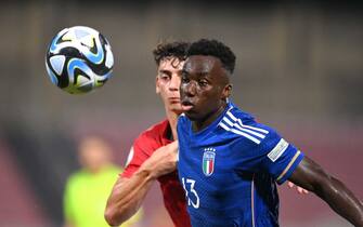 TA' QALI, MALTA - JULY 3: Michael Olabode Kayode of Italy in action against Nathan Cross of Malta during the UEFA European Under-19 Championship Finals 2022/23 group A match between Malta and Italy at the National Stadium on July 3, 2023 in Ta' Qali, Malta. (Photo by Seb Daly - Sportsfile/UEFA via Getty Images)