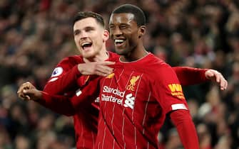 English Premier League Soccer Liverpool's Georginio Wijnaldum (right) celebrates scoring his side's fifth goal of the game with team-mate Andrew Robertson during the Premier League match at Anfield, Liverpool.