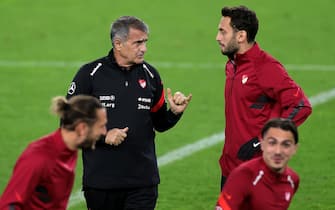 epa08725090 Turkey's head coach Senol Guenes (L) and Turkey's Hakan Calhanoglu (R) attend a training session at the Rheinenergiestadion in Cologne, Germany, 06 October 2020. Turkey will face Germany in an international friendly soccer match on 07 October 2020 in Cologne. The city of Cologne has decided that the international match of the German national team against Turkey may take place with a maximum of 300 spectators due to the increased number of corona virus infections.  EPA/FRIEDEMANN VOGEL