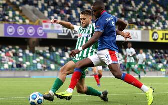 Zalgiris' Nemanja Ljubisavljevic (left) and Linfield's Christy Manzinga battle for the ball during the UEFA Champions League first qualifying round, second leg match at Windsor Park, Belfast. Picture date: Tuesday July 13, 2021.
