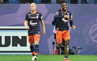 Montpellier's French forward Elye Wahi (R) celebrates with Montpellier's French midfielder Florent Mollet (L) after scoring his team's second goal during the French L1 football match between Montpellier Herault SC and FC Nantes at Stade de la Mosson in Montpellier, southern France on October 31, 2021. (Photo by Pascal GUYOT / AFP) (Photo by PASCAL GUYOT/AFP via Getty Images)