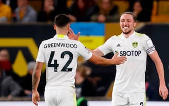 WOLVERHAMPTON, ENGLAND - MARCH 18: Luke Ayling of Leeds United celebrates after scoring a goal to make it 2-3 with Sam Greenwood of Leeds United during the Premier League match between Wolverhampton Wanderers and Leeds United at Molineux on March 18, 2022 in Wolverhampton, United Kingdom. (Photo by James Baylis - AMA/Getty Images)