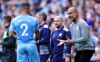 Manchester City manager Pep Guardiola with Kyle Walker during the Premier League match at The Etihad Stadium, Manchester. Picture date: Saturday September 18, 2021.