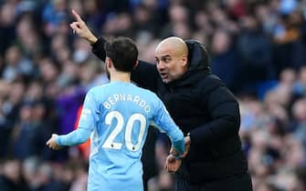 Manchester City manager Pep Guardiola (right) instructs Bernardo Silva from the touchline during the Premier League match at the Etihad Stadium, Manchester. Picture date: Sunday March 6, 2022.