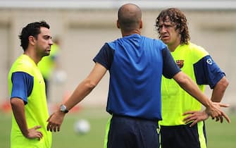 Barcelona FC head coach Josep Guardiola (C) speaks to captain Carles Puyol (R) and vice-captain Xavi Hernandez during a training session at UCLA in Los Angeles, California on July 30, 2009. Barcelona will face the Los Angeles Galaxy on August 1in Pasadena, California.  AFP PHOTO / GABRIEL BOUYS (Photo credit should read GABRIEL BOUYS/AFP via Getty Images)