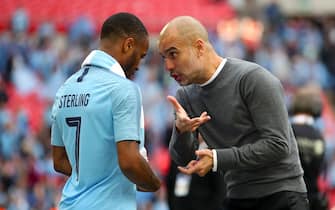 Manchester City's Raheem Sterling (left) and Manchester City manager Pep Guardiola speak after the final whistle of the FA Cup Final at Wembley Stadium, London.