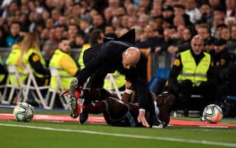 Real Madrid's French coach Zinedine Zidane (up) collides with Celta Vigo's Ghanaian defender Joseph Aidoo (down) during the Spanish league football match between Real Madrid CF and RC Celta de Vigo at the Santiago Bernabeu stadium in Madrid on February 16, 2020. (Photo by PIERRE-PHILIPPE MARCOU / AFP) (Photo by PIERRE-PHILIPPE MARCOU/AFP via Getty Images)