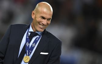Real Madrid's French coach Zinedine Zidane smiles with his medal after winning the UEFA Super Cup football match between Real Madrid and Manchester United on August 8, 2017, at the Philip II Arena in Skopje. / AFP PHOTO / Dimitar DILKOFF        (Photo credit should read DIMITAR DILKOFF/AFP/Getty Images)