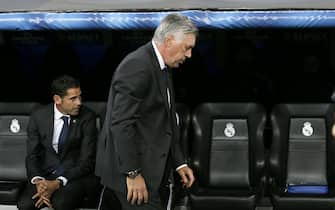 Real Madrid's Italian head coach Carlo Ancelotti (R) sits on the bench before the UEFA Champions League Group B soccer match between Real Madrid and FC Basel at Santiago Bernabeu stadium in Madrid, Spain, 16 September 2014. EFE/Juanjo Martin