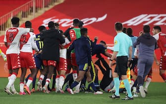 Players clash a the end of the L1 football match between Monaco (ASM) and Lyon (OL) at The Louis II Stadium, in Monaco on May 2, 2021. (Photo by Valery HACHE / AFP) (Photo by VALERY HACHE/AFP via Getty Images)