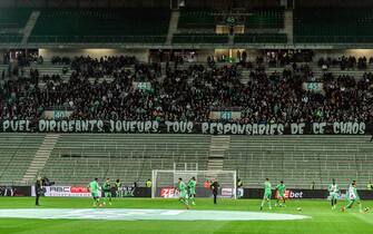 1236053601 AS Saint-Etienne supporters display a banner which reads as "Puel (Saint-Etienne's France' head coach), managers, players, all responsible for this chaos" to protest against the last place of AS Saint-Etienne football club in the ranking of the French L1 championship, prior to the start of the French L1 football match between AS Saint-Etienne and SCO Angers at the Geoffroy Guichard stadium in Saint-Etienne, central France, on October 22, 2021. - Incidents broke out during the pre-match protocol Saint-Etienne/Angers of the 11th day of Ligue 1, caused by the ultras groups of the club stéphanois, and the kickoff of the game scheduled for 21:00 has been delayed. (Photo by PHILIPPE DESMAZES / AFP) (Photo by PHILIPPE DESMAZES/AFP via Getty Images)