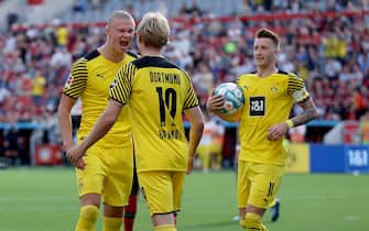 LEVERKUSEN, GERMANY - SEPTEMBER 11: (L-R) Erling Haaland, Julian Brandt and Marco Reus of Dortmund celebrate their teams second goal during the Bundesliga match between Bayer 04 Leverkusen and Borussia Dortmund at BayArena on September 11, 2021 in Leverkusen, Germany. (Photo by Joosep Martinson/Getty Images)