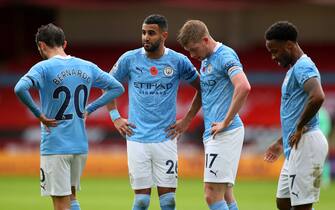 SHEFFIELD, ENGLAND - OCTOBER 31: A poppy is seen on the shirt of Riyah Mahrez of Manchester City as he stands with team mates Bernardo Silva, Kevin De Bruyne and Raheem Sterling of Manchester City  during the Premier League match between Sheffield United and Manchester City at Bramall Lane on October 31, 2020 in Sheffield, England. Sporting stadiums around the UK remain under strict restrictions due to the Coronavirus Pandemic as Government social distancing laws prohibit fans inside venues resulting in games being played behind closed doors. (Photo by Catherine Ivill/Getty Images)