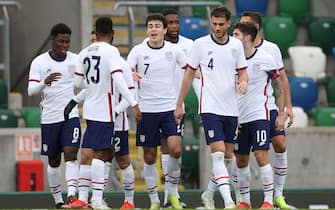 USA's Giovanni Reyna (7) celebrates with team-mates after scoring their side's first goal of the game during the international friendly at Windsor Park, Belfast. Picture date: Sunday March 28, 2021.