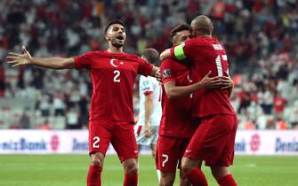 epa09441427 Turkey's Cengiz Under (C) celebrates with team mates Burak Yilmaz (R) and Zeki Celik (L) after scoring the 1-0 lead during the FIFA World Cup 2022 qualifying group G match between Turkey and Montenegro in Istanbul, Turkey 01 September 2021.  EPA/TOLGA BOZOGLU