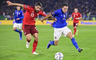 epa09579428 Switzerland's defender Ricardo Rodriguez (L) fights for the ball against Italy's forward Federico Chiesa during the 2022 FIFA World Cup European Qualifying Group C match between Italy and Switzerland at the Stadio Olimpico in Rome, Italy, 12 November 2021.  EPA/JEAN-CHRISTOPHE BOTT