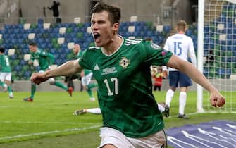Norther Ireland's Paddy McNair celebrates after Slovakia's Milan Skriniar (not pictured) scores an own goal during the UEFA Euro 2020 Play-off Finals match at Windsor Park, Belfast.