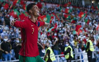 epa09521037 Cristiano Ronaldo of Portugal celebrates after scoring a goal against Luxembourg during the FIFA World Cup 2022 qualifying group A soccer match at Algarve Stadium in Loule, Portugal, 12 October 2021.  EPA/ANTONIO COTRIM