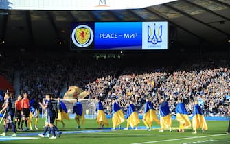 GLASGOW, SCOTLAND - JUNE 01: The Ukraine players walk onto the pitch each draped in their national flag before the FIFA World Cup Qualifier Play-Off Semi-Final match between Scotland and Ukraine at Hampden Park on June 1, 2022 in Glasgow, Scotland. (Photo by Simon Stacpoole/Offside/Offside via Getty Images)