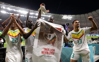DOHA, QATAR - NOVEMBER 29: Senegal players applaud fans with a banner of Papa Bouba Diop, on the 2nd anniversary of his death, after their 2-1 victory in the FIFA World Cup Qatar 2022 Group A match between Ecuador and Senegal at Khalifa International Stadium on November 29, 2022 in Doha, Qatar. (Photo by Buda Mendes/Getty Images)