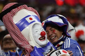 TOPSHOT - Japan supporters celebrate after their team won the Qatar 2022 World Cup Group E football match between Japan and Spain at the Khalifa International Stadium in Doha on December 1, 2022. (Photo by ADRIAN DENNIS / AFP) (Photo by ADRIAN DENNIS/AFP via Getty Images)