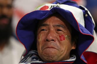 A Japan supporter celebrates after his team won the Qatar 2022 World Cup Group E football match between Japan and Spain at the Khalifa International Stadium in Doha on December 1, 2022. (Photo by Adrian DENNIS / AFP) (Photo by ADRIAN DENNIS/AFP via Getty Images)