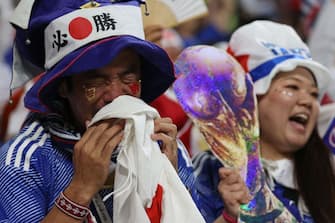 A Japan supporter celebrates after his team won the Qatar 2022 World Cup Group E football match between Japan and Spain at the Khalifa International Stadium in Doha on December 1, 2022. (Photo by ADRIAN DENNIS / AFP) (Photo by ADRIAN DENNIS/AFP via Getty Images)