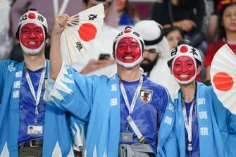 DOHA, QATAR - DECEMBER 01: Fans of Japan cheer for their team during the FIFA World Cup Qatar 2022 Group E match between Japan and Spain at Khalifa International Stadium on December 1, 2022 in Doha, Qatar. (Photo by Khalil Bashar/Jam Media/Getty Images)