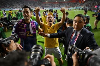 DOHA, QATAR - DECEMBER 01: Maya Yoshida and Yuto Nagatomo of Japan applaud fans after their 2-1 victory and qualification for the knockout stage after the FIFA World Cup Qatar 2022 Group E match between Japan and Spain at Khalifa International Stadium on December 01, 2022 in Doha, Qatar. (Photo by Clive Mason/Getty Images)