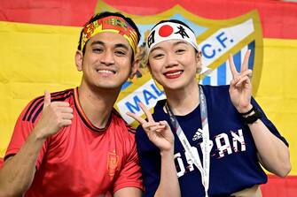 A Spain supporter and a Japan supporter attend the start of the Qatar 2022 World Cup Group E football match between Japan and Spain at the Khalifa International Stadium in Doha on December 1, 2022. (Photo by JAVIER SORIANO / AFP) (Photo by JAVIER SORIANO/AFP via Getty Images)