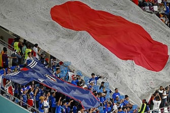 Japan fans display a giant Japan flag prior to the Qatar 2022 World Cup Group E football match between Japan and Spain at the Khalifa International Stadium in Doha on December 1, 2022. (Photo by Jewel SAMAD / AFP) (Photo by JEWEL SAMAD/AFP via Getty Images)