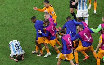 epa10358128 Players of the Netherlands urge Leandro Paredes of Argentina to get off of the ground during the FIFA World Cup 2022 quarter final soccer match between the Netherlands and Argentina at Lusail Stadium in Lusail, Qatar, 09 December 2022.  EPA/Abir Sultan