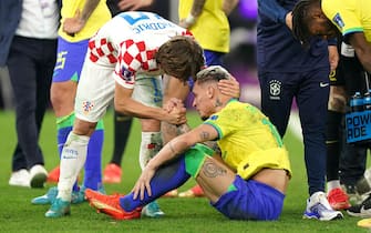 Brazil's Antony (right) is consoled by Croatia's Luka Modric after the penalty shootout following extra time during the FIFA World Cup Quarter-Final match at the Education City Stadium in Al Rayyan, Qatar. Picture date: Friday December 9, 2022.