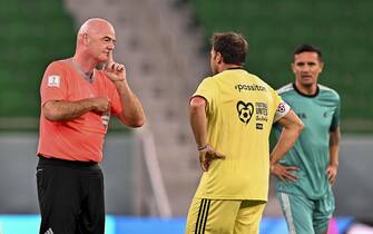 epa10362407 FIFA president Gianni Infantino (L) argues with former Italian player Alessandro Del Piero (C) during the Workers and FIFA Legends soccer match at Al Thumama Stadium in Doha, Qatar, 12 December 2022. FIFA World Cup 2022 guests and volunteers watched workers and FIFA legends playing in a 60-minute match.  EPA/NOUSHAD THEKKAYIL