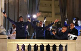 Olivier Giroud, Antoine Griezmann of Team France react with fans at the balcony of the Hotel de Crillon during the meeting with French fans at Place de la Concorde on December 19, 2022 in Paris, France.