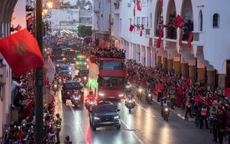epa10375058 Moroccan national soccer team players cheer during an open top bus parade upon their return from the FIFA World Cup 2022 soccer tournament in Qatar, in Rabat, Morocco, 20 December 2022.  EPA/Jalal Morchidi