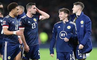epa09584360 Scotland's Che Adams (L), Scotland's Kenny McLean (2-L) and Scotland's Billy Gilmour (2-R) react after the FIFA World Cup 2022 group F qualifying soccer match between Scotland and Denmark in Glasgow, Britain, 15 November 2021.  EPA/ROBERT PERRY