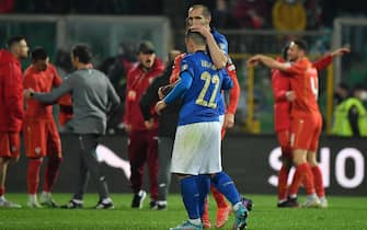 ItalyÕs defender Giorgio Chiellini and ItalyÕs forward Giacomo Raspadori dejection at the end of the FIFA World Cup Qatar 2022 play-off qualifying soccer match between Italy and North Macedonia at the Renzo Barbera stadium in Palermo, Sicily island, Italy, 24 March 2022. ANSA/CARMELO IMBESI