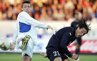 REYKJAVIK, ICELAND:  Italy's forward Toni (R) challenges Iceland's Gylfi Einarsson during their international friendly football match at Laugardalsvollur stadium in Reykjavik 18 August 2004. Iceland won the match 2-0.  AFP PHOTO PAOLO COCCO  (Photo credit should read PAOLO COCCO/AFP via Getty Images)