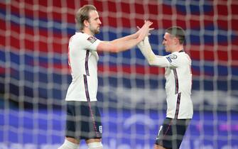 epa09109115 England's Harry Kane (L) reacts with England' Phil Foden (R) after he scores the 1-0 goal from a penalty during the FIFA World Cup 2022 qualifying soccer match between England and Poland in London, Britain, 31 March 2021.  EPA/Catherine Ivill / POOL