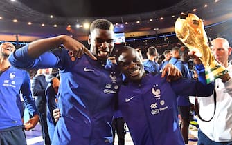 Paul Pogba and N'Golo Kanté with the 2018 World Cup trophy as they celebrate during a ceremony for the victory of the 2018 World Cup at the end of the UEFA Nations League football match between France and Netherlands at the Stade de France stadium, in Saint-Denis, northern of Paris, on September 9, 2018.