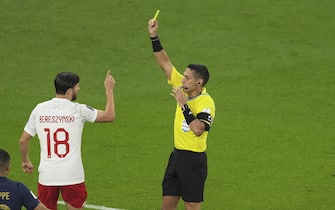 (221204) -- DOHA, Dec. 4, 2022 (Xinhua) -- Bartosz Bereszynski (C) of Poland receives a yellow card from referee Jesus Valenzuela Saez (R) during the Round of 16 match between France and Poland of the 2022 FIFA World Cup at Al Thumama Stadium in Doha, Qatar, Dec. 4, 2022. (Xinhua/Meng Yongmin) - Meng Yongmin -//CHINENOUVELLE_CHINENOUVELLE1192/Credit:CHINE NOUVELLE/SIPA/2212041807/Credit:CHINE NOUVELLE/SIPA/2212041816