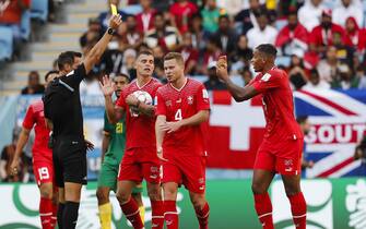 Referee Facundo Tello shows a yellow card to Manuel Akanji of Switzerland as Granit Xhaka and Nico Elvedi complain during the 2022 FIFA World Cup Group G match at Al Janoub Stadium, Al Wakrah
Picture by Paul Chesterton/Focus Images/Sipa USA 
24/11/2022