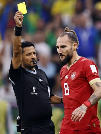 LUSAIL CITY - (l-r) Referee Alireza Faghani gives the yellow card to Nemanja Gudelj of Serbia during the FIFA World Cup Qatar 2022 group G match between Brazil and Serbia at Lusail Stadium on November 24, 2022 in Lusail City, Qatar. AP | Dutch Height | MAURICE OF STONE /ANP/Sipa USA