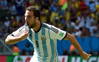 epa04300946 Gonzalo Higuain of Argentina celebrates  after scoring the opening goal during the FIFA World Cup 2014 quarter final match between Argentina and Belgium at the Estadio Nacional in Brasilia, Brazil, 05 July 2014. (RESTRICTIONS APPLY: Editorial Use Only, not used in association with any commercial entity - Images must not be used in any form of alert service or push service of any kind including via mobile alert services, downloads to mobile devices or MMS messaging - Images must appear as still images and must not emulate match action video footage - No alteration is made to, and no text or image is superimposed over, any published image which: (a) intentionally obscures or removes a sponsor identification image; or (b) adds or overlays the commercial identification of any third party which is not officially associated with the FIFA World Cup)  EPA/PETER POWELL   EDITORIAL USE ONLY