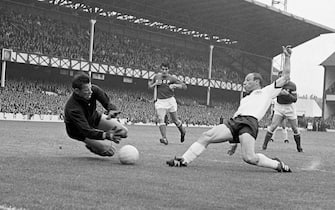 Russia's Lev Yashin dives to catch the ball kicked by West Germany's centre-forward Uwe Seeler,( right) during the World Cup semi-final at Goodison Park, Liverpool. West Germany won the match, 2-1.
