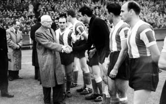 Originator of the World Cup, Frenchman Jules Rimet (l), shakes hands with Argentina goalkeeper Miguel Rugilo (third r) as the teams are introduced to him before the match  (Photo by Barratts/PA Images via Getty Images)